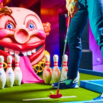 Children playing mini golf indoors during EduCare Spring School Holiday Social Group in Charlestown