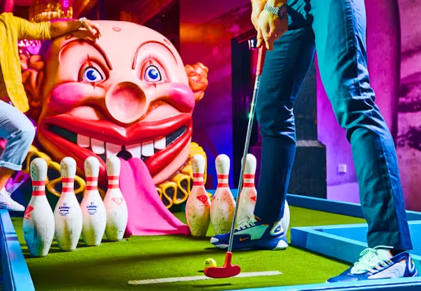 Children playing mini golf indoors during EduCare Spring School Holiday Social Group in Charlestown