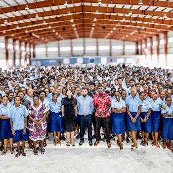 Large group of students gathered in a school hall in Vanuatu for a mental health education session focused on wellbeing and coping strategies